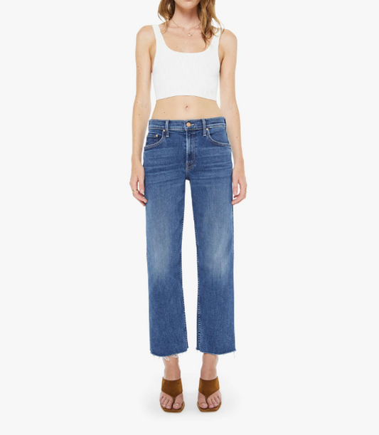 Woman wearing blue jeans and a white top on a white background